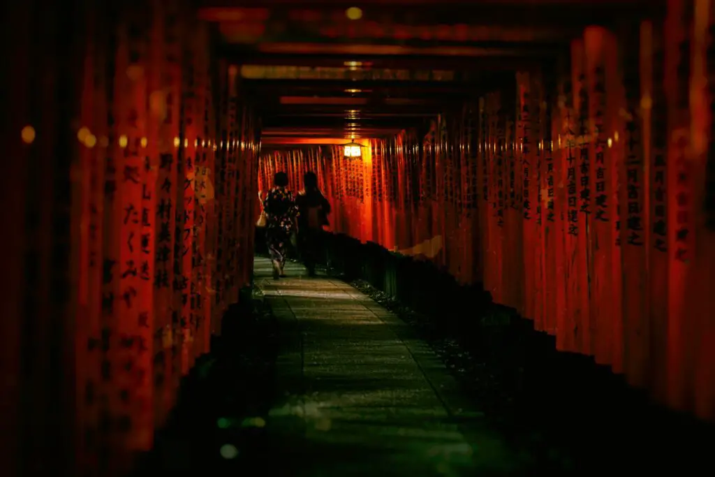 two person walking through a tunnel